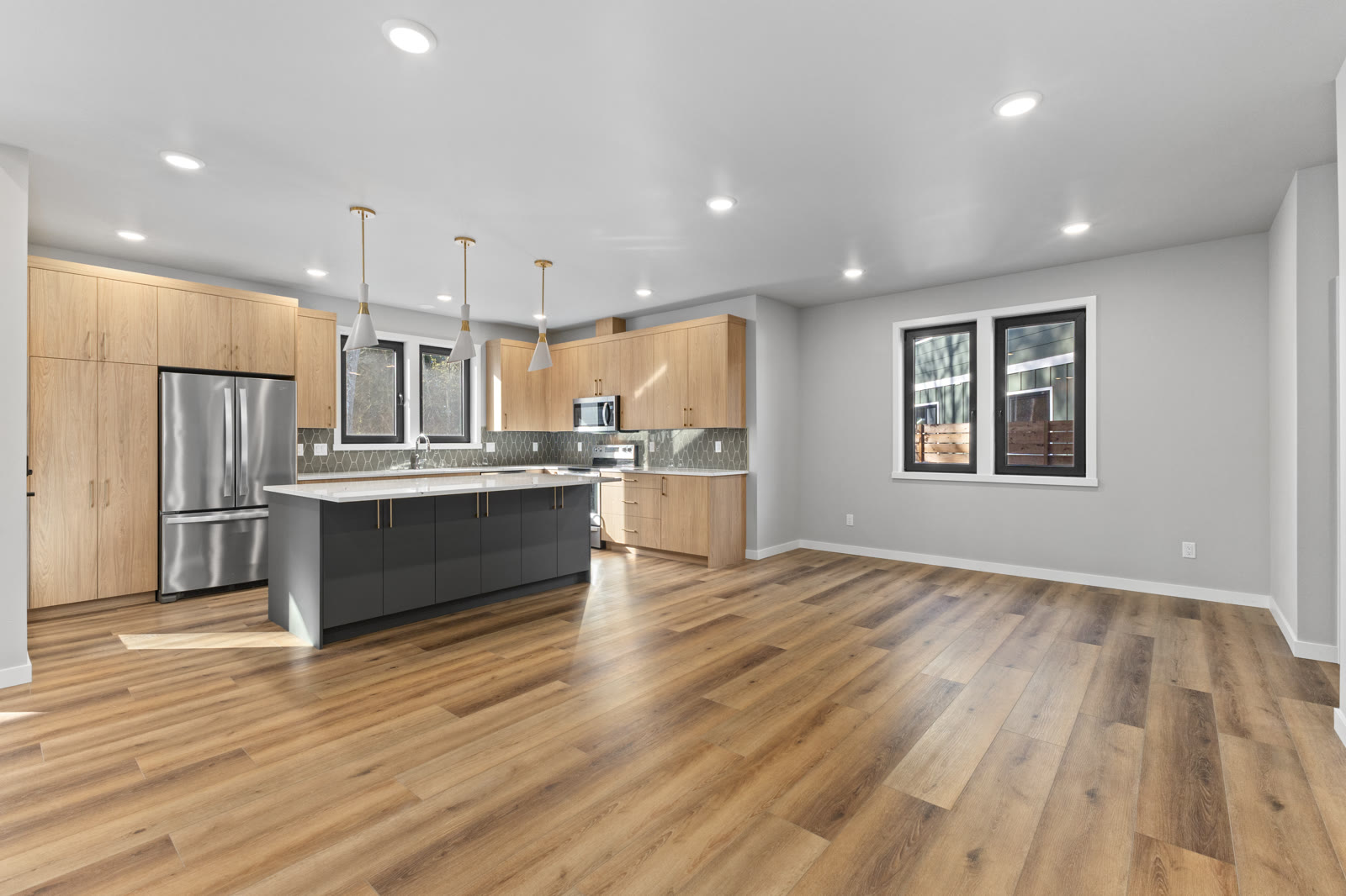 Light wood two-tone kitchen remodel with gray island and quartz countertops